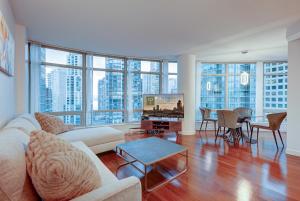 a living room with a couch and a tv and a table at Dunowen Properties in Vancouver