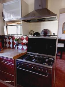 a kitchen with a black stove top oven at La rivierette in Doingt