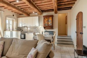 a living room and kitchen with a couch and a table at Villa Petri in Uzzano