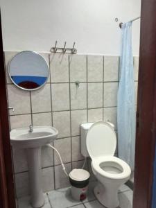 a bathroom with a toilet and a sink and a mirror at Pousada Taiwan in Ubatuba +15 photos