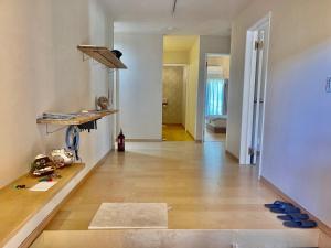 a living room with a wooden floor and white walls at Yoronto - Vacation STAY 18850v in Yoron