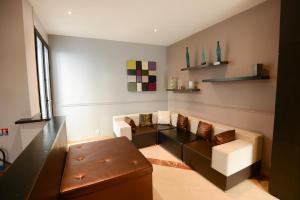 a living room with a couch and a table at HOTEL WATTIGNIES in Paris