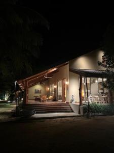 a house at night with a porch and a table at Allure Yala Luxury Suites by Allure Leisure in Yala