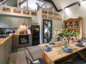 a kitchen with a wooden table in a room at The Old Mission Hall in Richmond