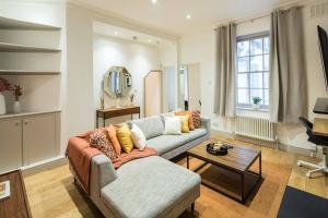 a living room with a couch and a table at Superb Retreat Central Next Tube in London