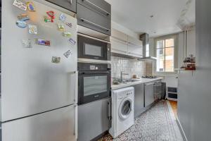 a kitchen with a refrigerator and a washer and dryer at Superb apartment of 50 m in Gentilly in Gentilly