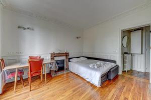 a bedroom with a bed and a desk and a table at Superb apartment of 50 m in Gentilly in Gentilly