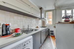 a kitchen with a sink and a stove at Superb apartment of 50 m in Gentilly in Gentilly