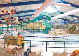 a pool with a water park with people in it at Seaside Escape at Trecco Bay in Porthcawl
