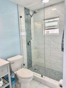 a bathroom with a shower and a toilet at Beachfront Bungalow in Clearwater Beach