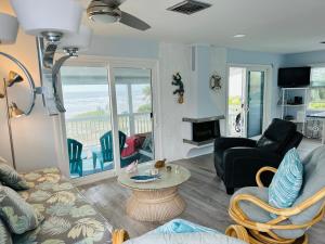 a living room with a couch and a table at Beachfront Bungalow in Clearwater Beach