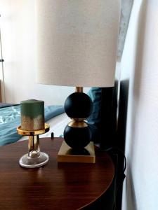 a lamp sitting on a table next to a bed at Central and calm appartement in Aachen in Aachen