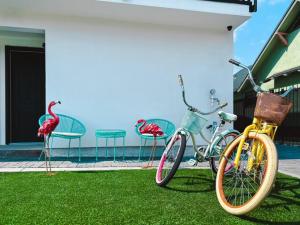 three bikes parked on the grass next to a house at THE SECRET GARDEN in Los Angeles