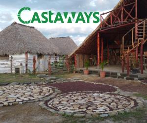 a group of huts with a sign that reads casaways at Castaways Nicaragua in Popoyo