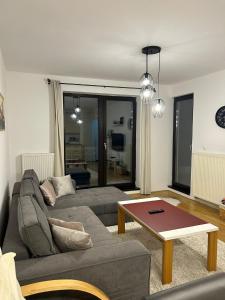 a living room with a couch and a coffee table at Apartment Bjelasnica in Bjelašnica