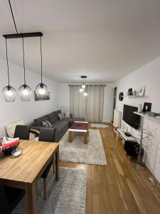 a living room with a couch and a table at Apartment Bjelasnica in Bjelašnica +5 photos