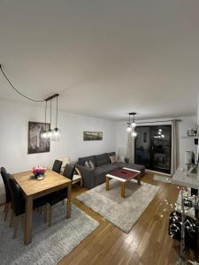 a living room with a couch and a table at Apartment Bjelasnica in Bjelašnica