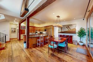 a kitchen with a wooden table and chairs at Silver King in Aspen