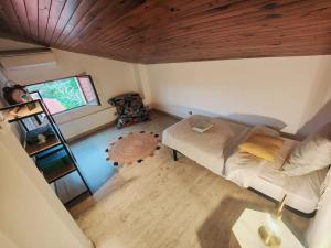 um pequeno quarto com uma cama e um tecto de madeira em Charmante petite maison magnifique vue mer em Propriano