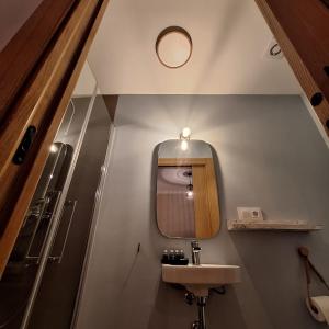 a bathroom with a sink and a mirror at Posada de la Clavería in Aldea del Rey