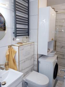 a white bathroom with a toilet and a sink at Zagreb Lux apartment in Zagreb