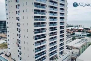 a white building with balconies on the side of it at Lindo apartamento com vista mar - Aquarius Residence in Fortaleza