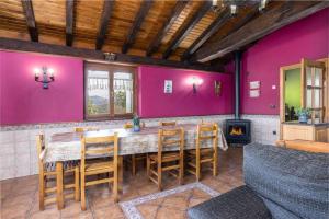 comedor con mesa, sillas y paredes rosas en ETXEORDEKOA. Apartamento con encanto en Plena Naturaleza, en Aia