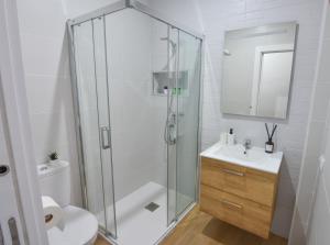 a bathroom with a shower and a toilet and a sink at AROMA APARTAMENTO OLVERA in Olvera +14 photos