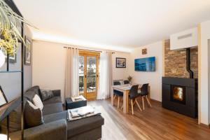 a living room with a couch and a table at Dany Lodge Livigno in Livigno