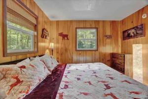 1 dormitorio con paredes de madera y 1 cama grande en *Bear Hugs Chalet* SKI*Games *NewHotTub*Fire Pit, en Lake Harmony