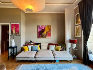 a living room with a couch with colorful pillows at Apartment PRIVE Zentrum in Leipzig