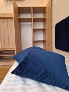 un oreiller bleu posé sur un lit dans une chambre dans l'établissement Pokoje Gościnne Koral, à Miasteczko Śląskie