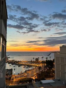 a sunset view of a city with a harbor at Mare Luna Apartment in Bari