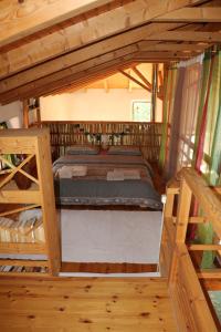 a bedroom in a tree house with a bed at The Strawhouse under the mountain 