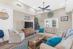 ein Wohnzimmer mit Sofa und Fernseher in der Unterkunft Laguna Matata by Book That Condo in Panama City Beach