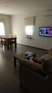 a living room with a couch and a table at Casa Amoblada p/ Alquiler Temporario - Bahía Blanca in Bahía Blanca