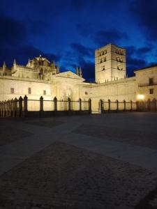 a building with a fence in front of it at night at La casita de Miguel, con garaje y piscina in Zamora