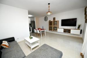 a living room with a couch and a table at CASA DRAGOS in Costa Teguise