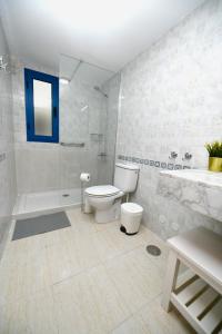 a white bathroom with a toilet and a shower at CASA DRAGOS in Costa Teguise