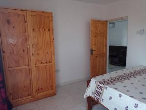 a bedroom with wooden cabinets and a bed in it at Suleimane guest in Sere Kunda