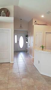 a large room with a door and a tile floor at Destin Miramar Walk To Beach Pet Friendly in Destin