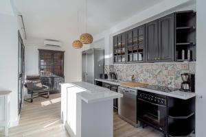 a kitchen with black cabinets and a counter top at Marina Vista Paradise Casasol in Nerja