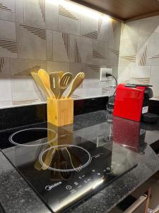 a kitchen with a counter top with wooden utensils at Studio 201 SP Moema Super Equipado in Sao Paulo