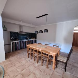 a dining room with a wooden table and chairs at Posada de la Clavería in Aldea del Rey +30 photos