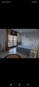 una grande camera da letto con un letto e una finestra di Amazing House In Costa Brava a Santa Susanna