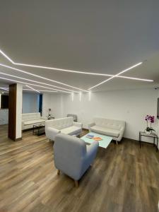 a waiting room with couches and tables in a building at Hotel Yolima Real in Bogotá