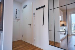 a room with white walls and glass partitions at Schön Wohnen auf der Allerinsel in Celle +5 photos