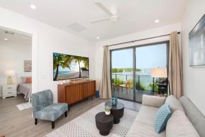 a living room with a couch and a large window at Allure #22 3BR Waterfront in Red Bay Estate