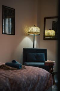a bedroom with a bed and a chair and a lamp at FiordalisoHouse-Stadio Olimpico in Turin