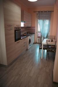 a kitchen with a table and a dining room at FiordalisoHouse-Stadio Olimpico in Turin